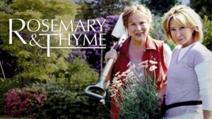 cosy mystery tv show rosemary and thyme. Two women stand in a garden, one has a shovel over her shoulder, both are looking at the camera.